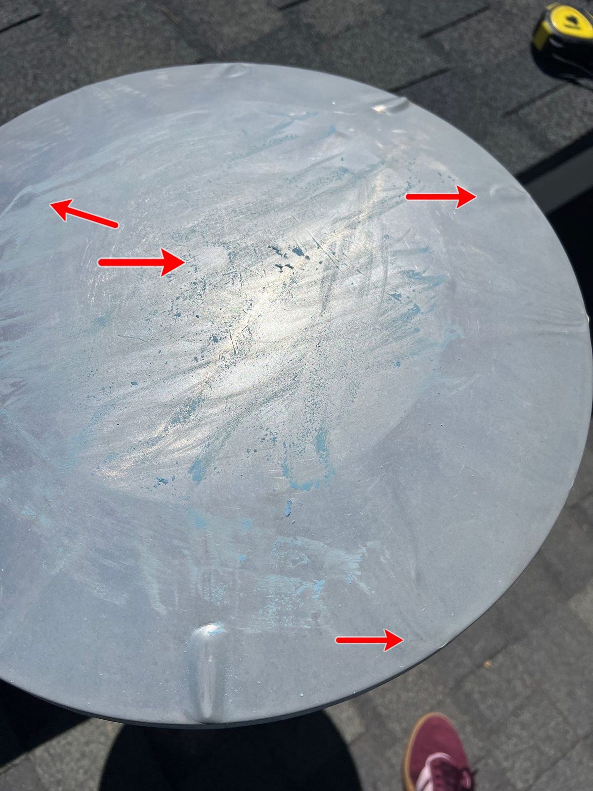 Hail dents circled on a metal roof surface