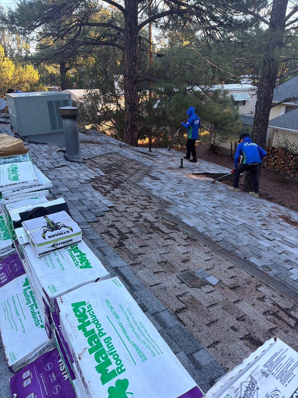 Shingle bundles staged on a roof during a replacement