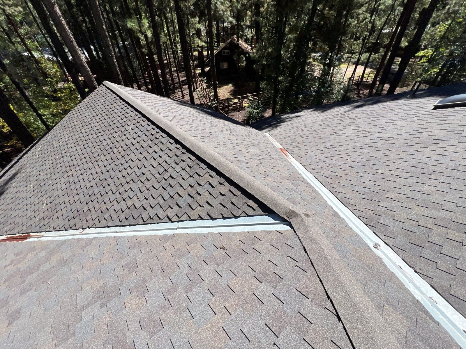Roofing crew installing new shingles on a home