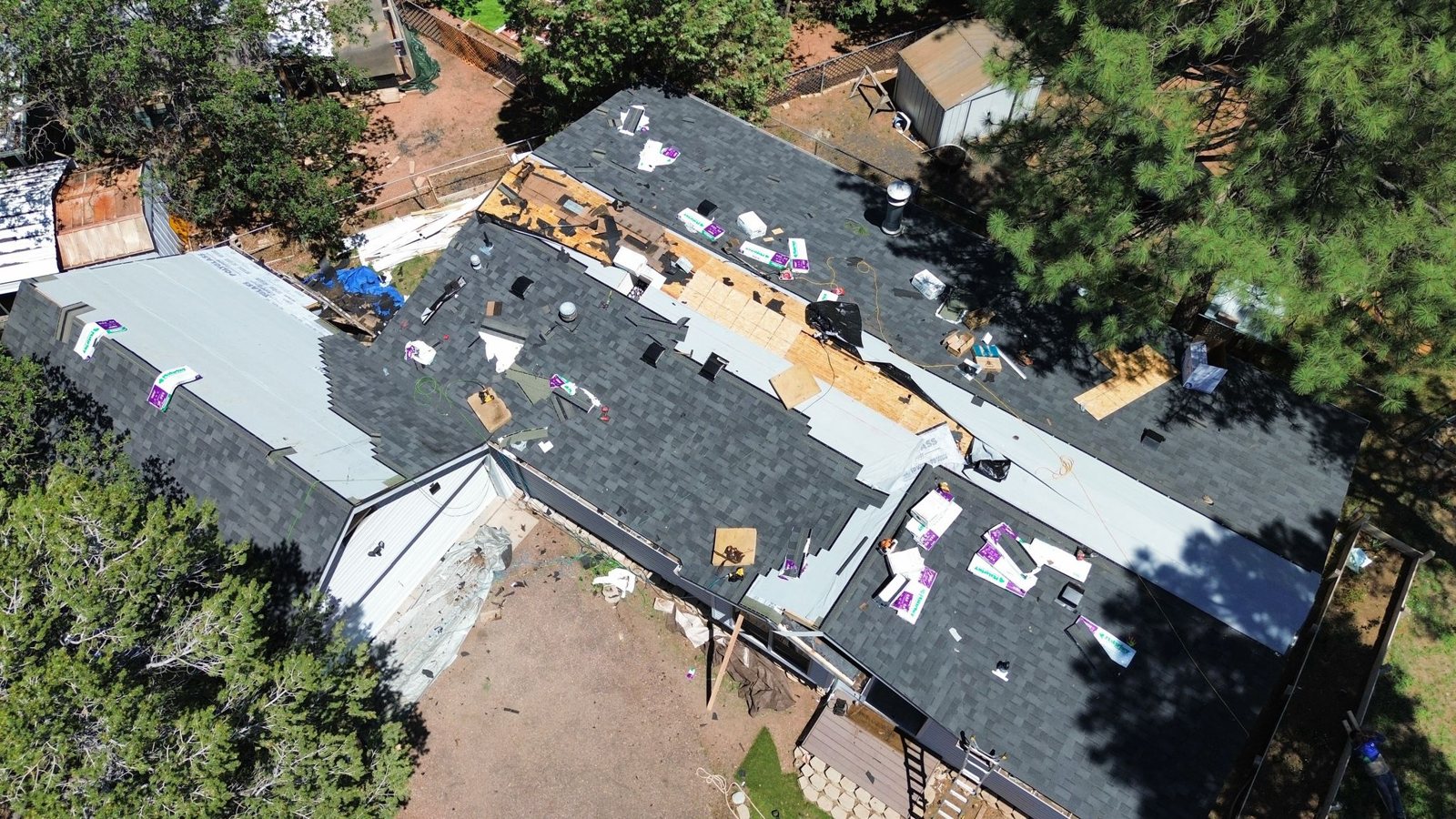 Slade crew installing a new shingle roof, seen by drone