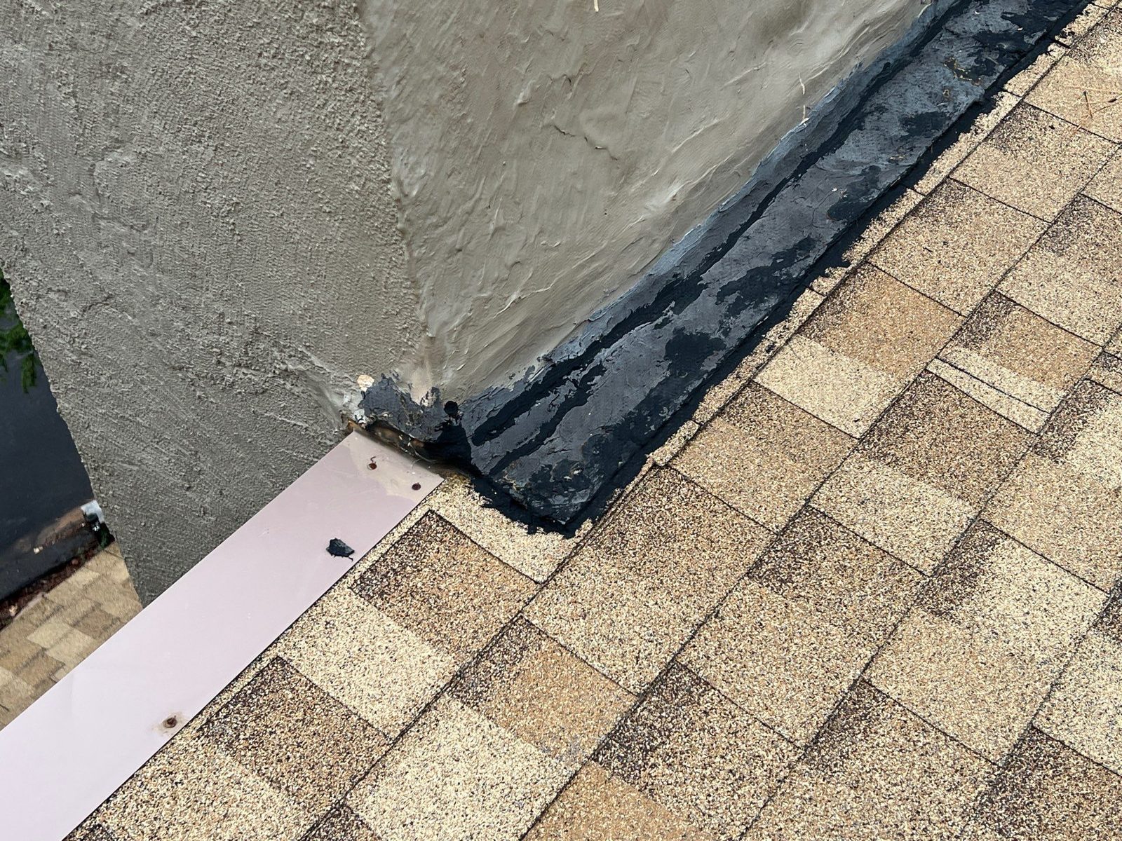 Sealed wall flashing on a shingle roof