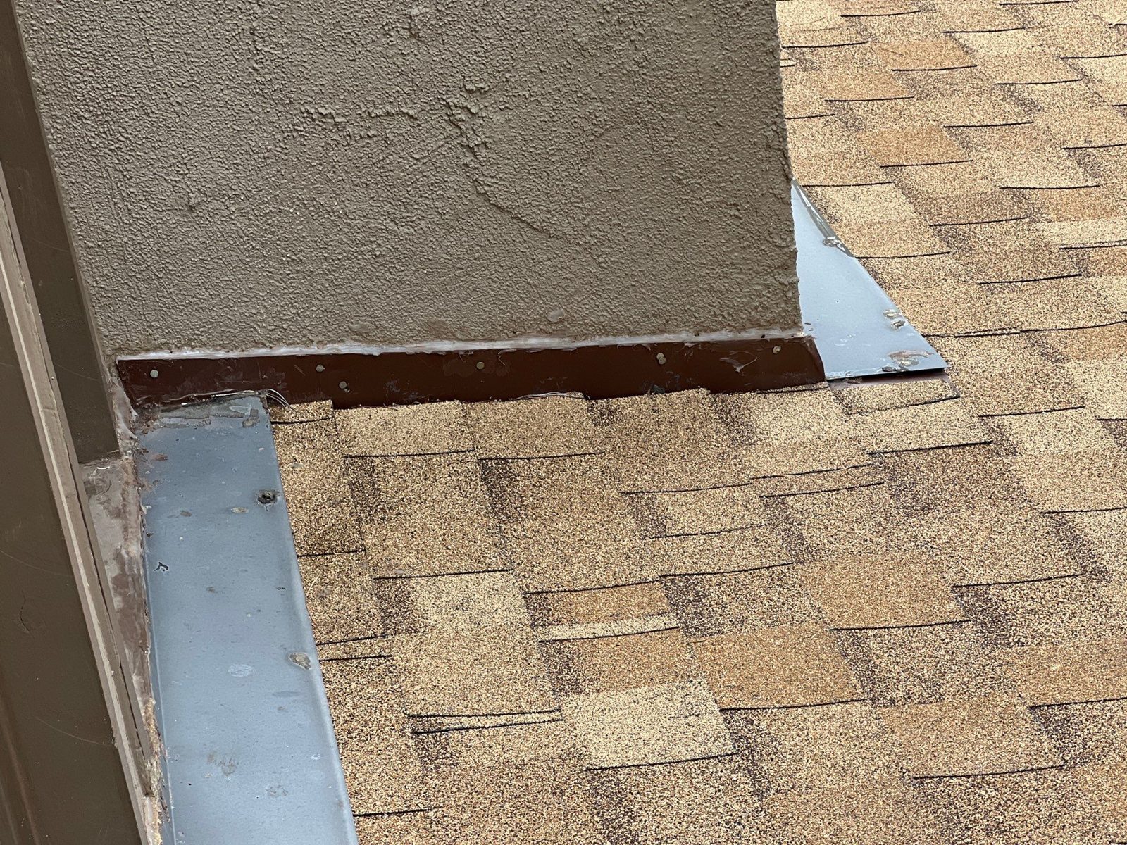 Wall and step flashing on a shingle roof