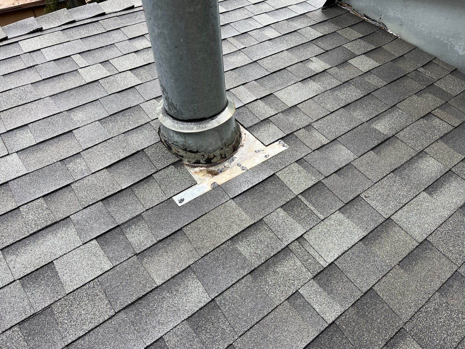 Pipe boot flashing on a shingle roof