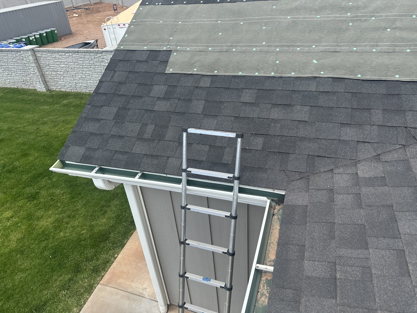 Woman inspecting ladder safety before roof access